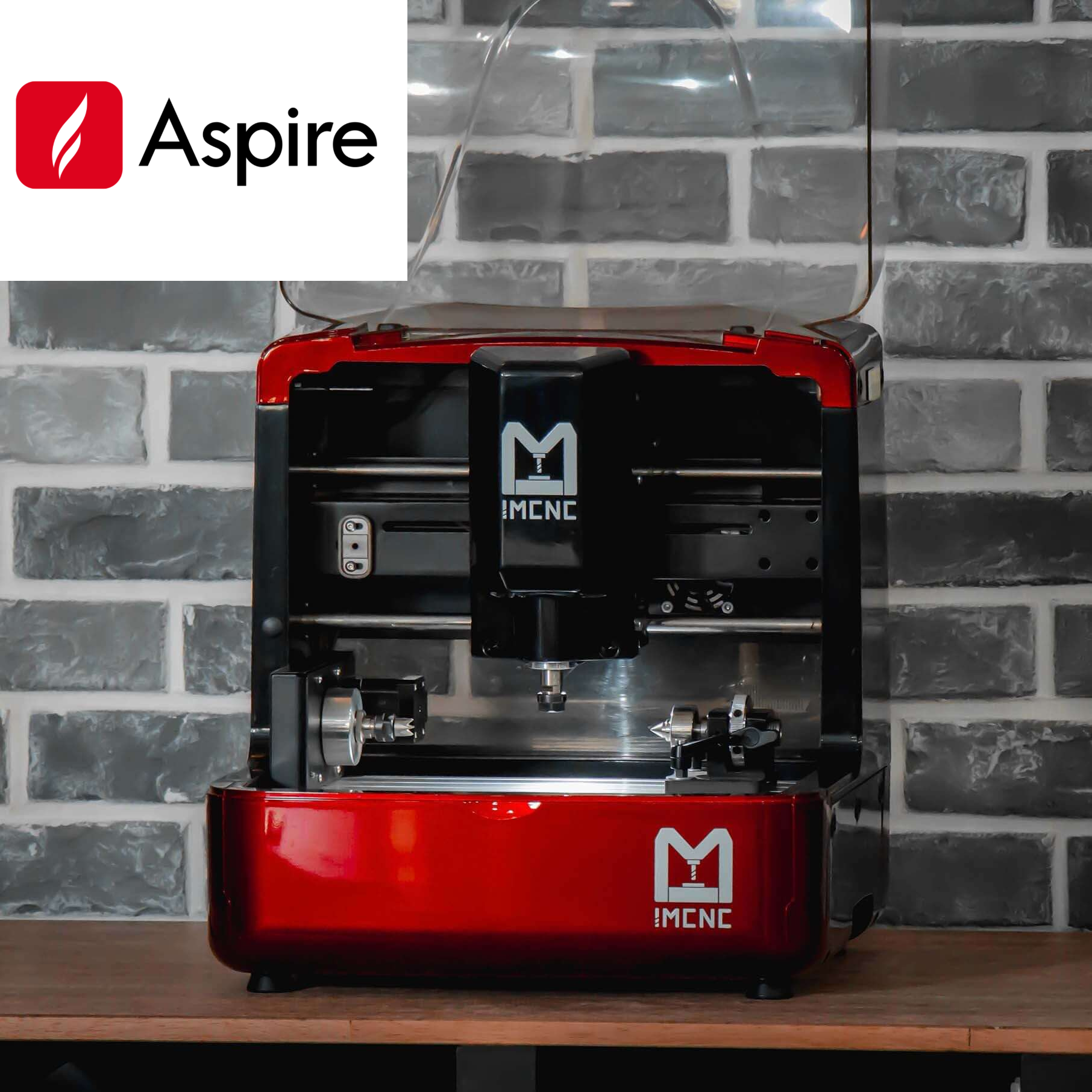 Close-up of IMCNC mini CNC machine with rotary axis attachment installed, red frame and spindle in view with software "Aspire icon", designed for cylindrical engraving