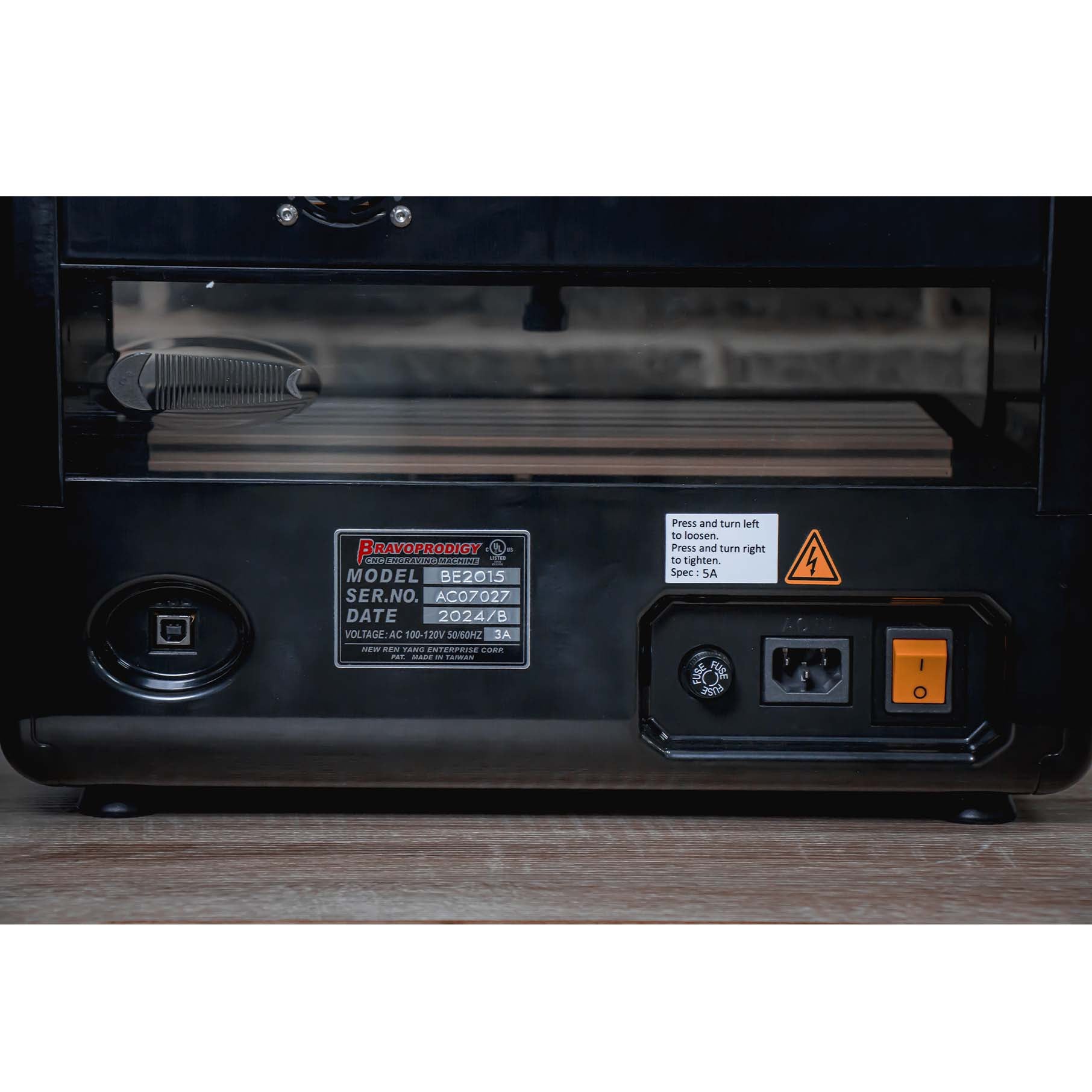 Close-up of the back panel of IMCNC mini CNC machine, showing model label, power switch, power port, and warning labels.