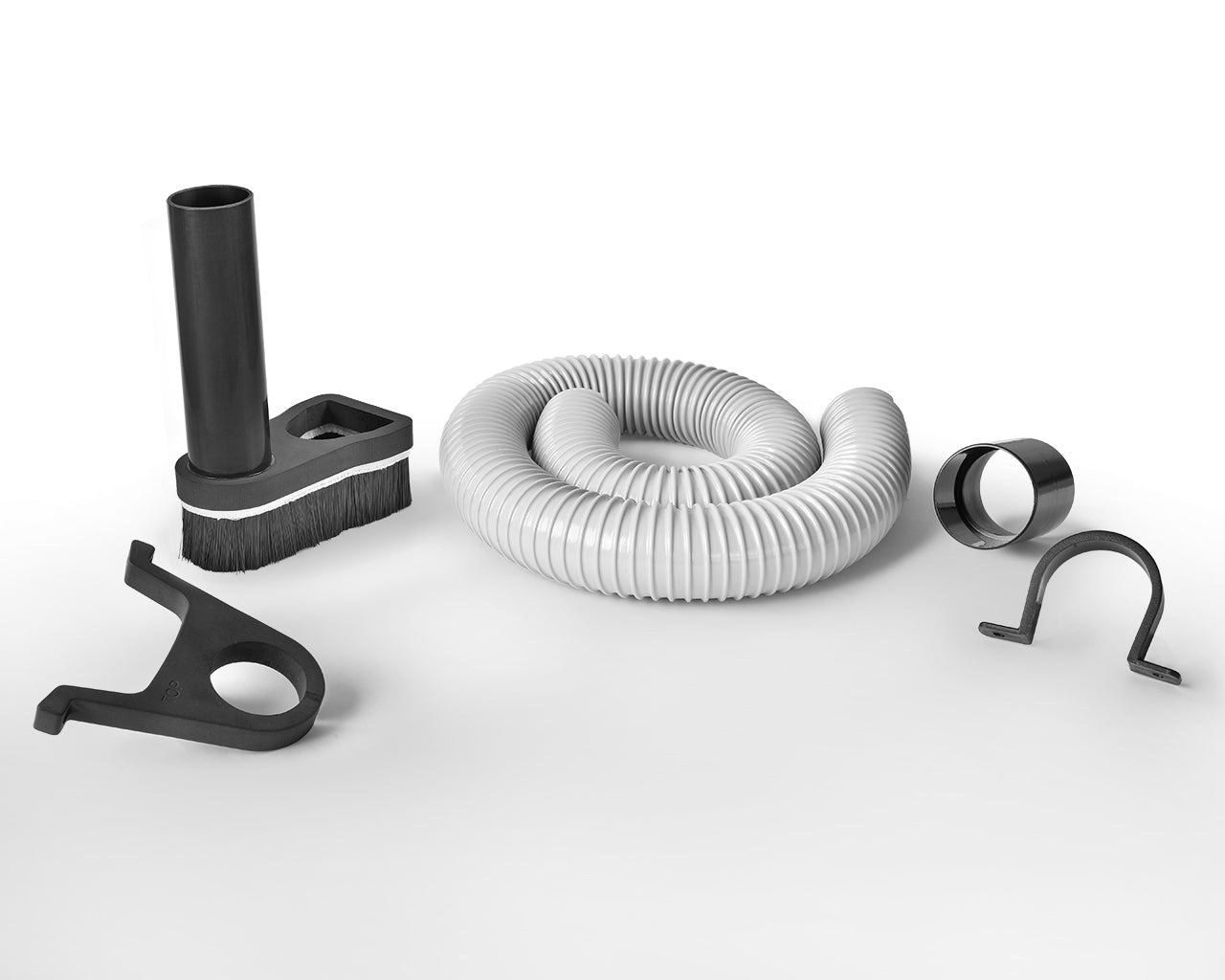 CNC dust collection kit with dust shoe, flexible hose, hose clamps, and mounting accessories for clean and efficient engraving operation.