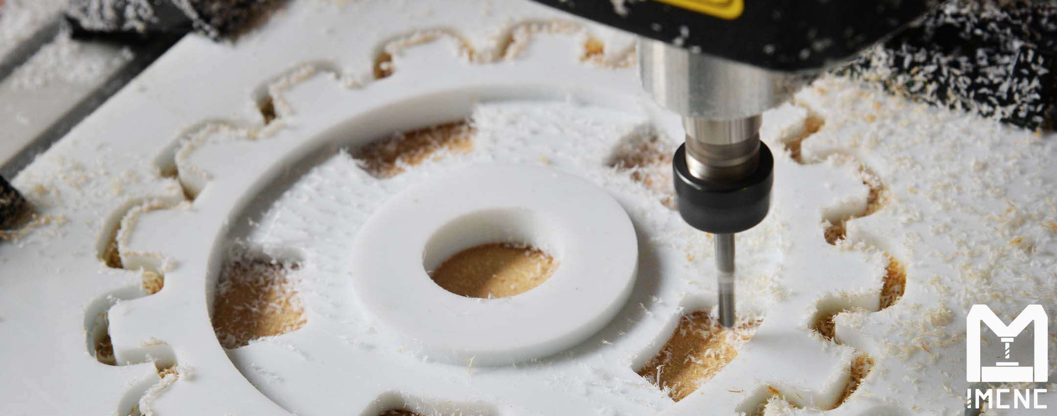 IMCNC BE3000 desktop CNC machine cutting acrylic gear shape using ER11 tool bits for precision milling.