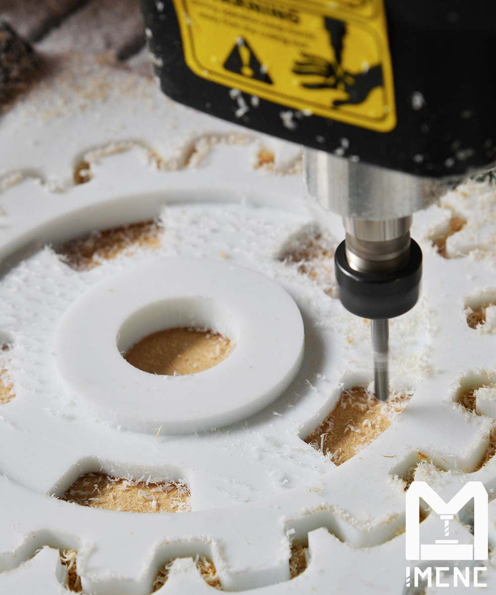 BE3000 desktop CNC machine cutting acrylic gear shape using ER11 tool bits for precision and clean results.