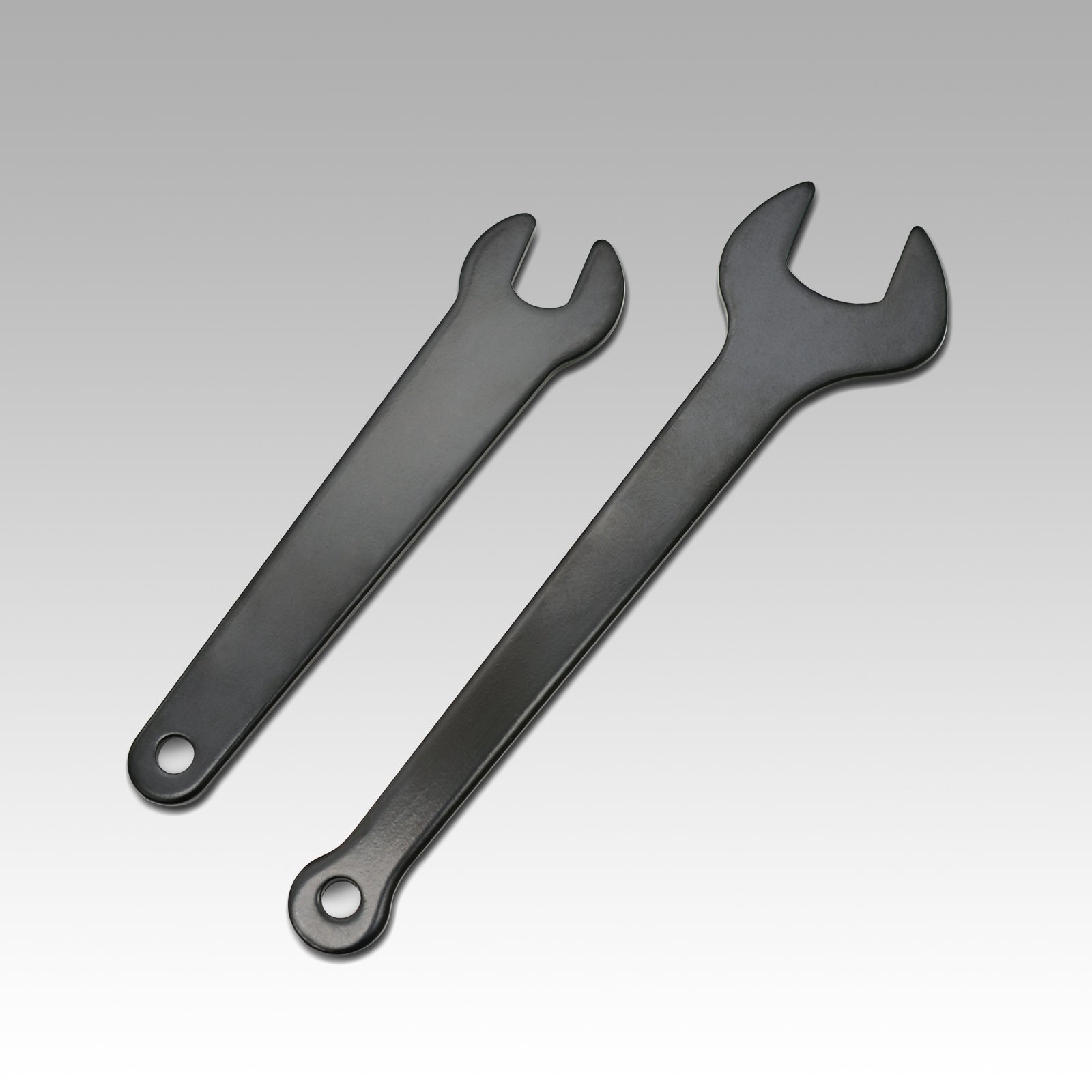 Two black open-end wrenches for CNC machine tool changing, displayed on white background.