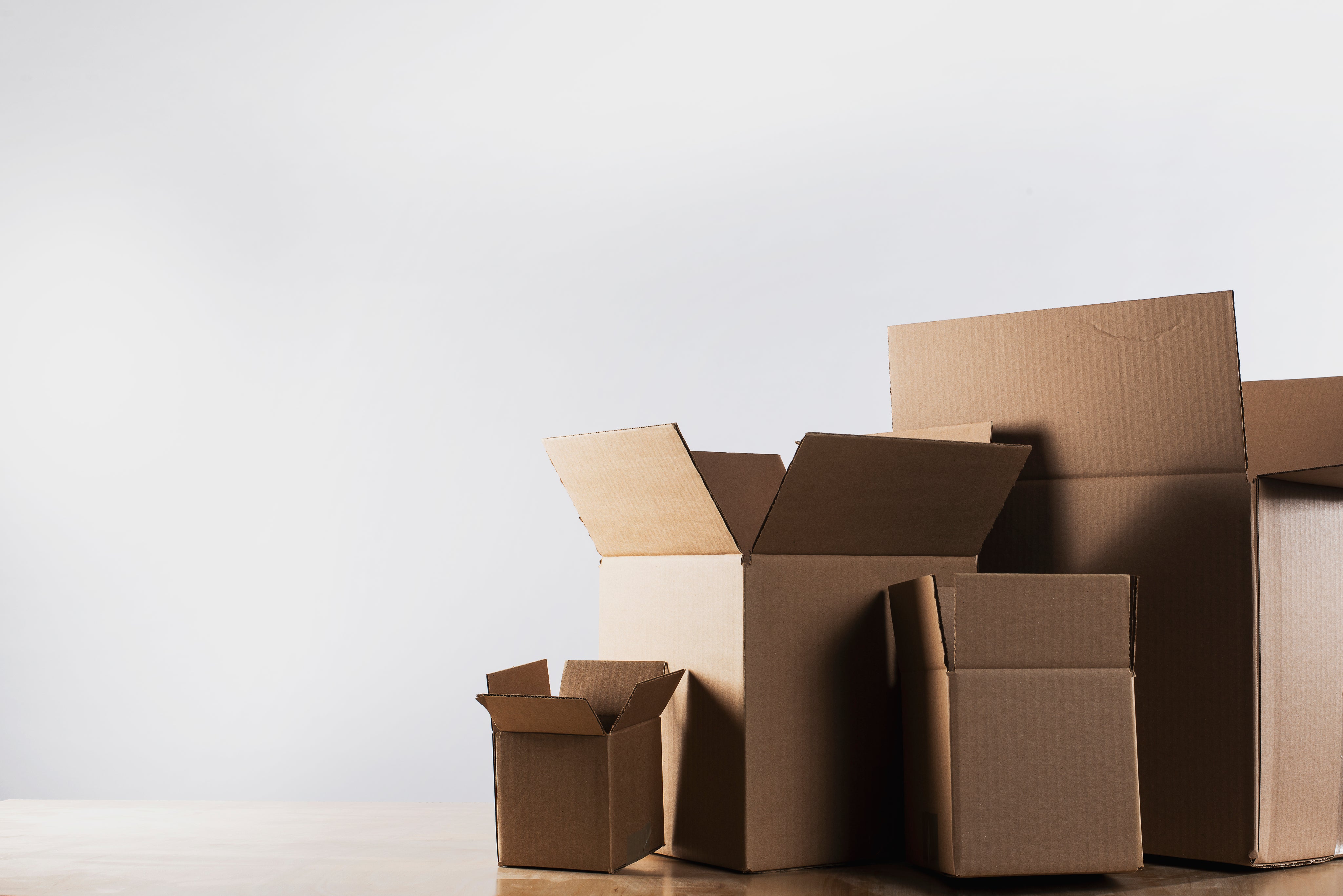 Empty boxes on the table, displayed on a white background, for webpage decoration