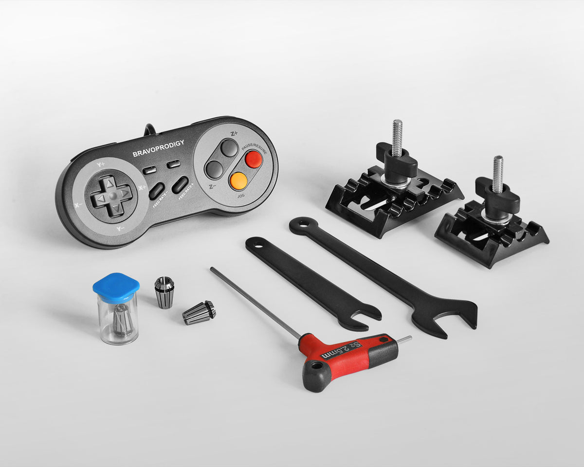 CNC router accessory kit including BRAVOPRODIGY CNC controller, clamps, collets, wrenches, screwdriver, and tool bits displayed on a white background.