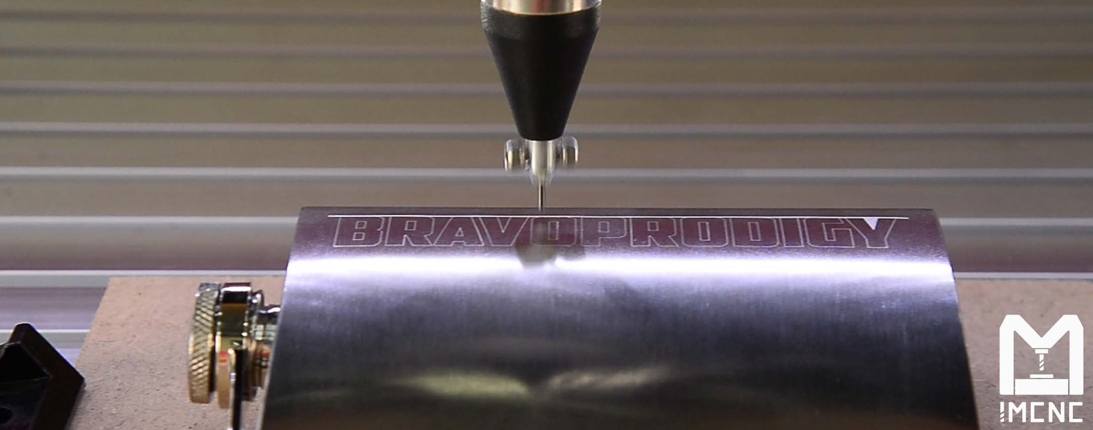 CNC machine using dot peen tool to mark text on aluminum bottle.