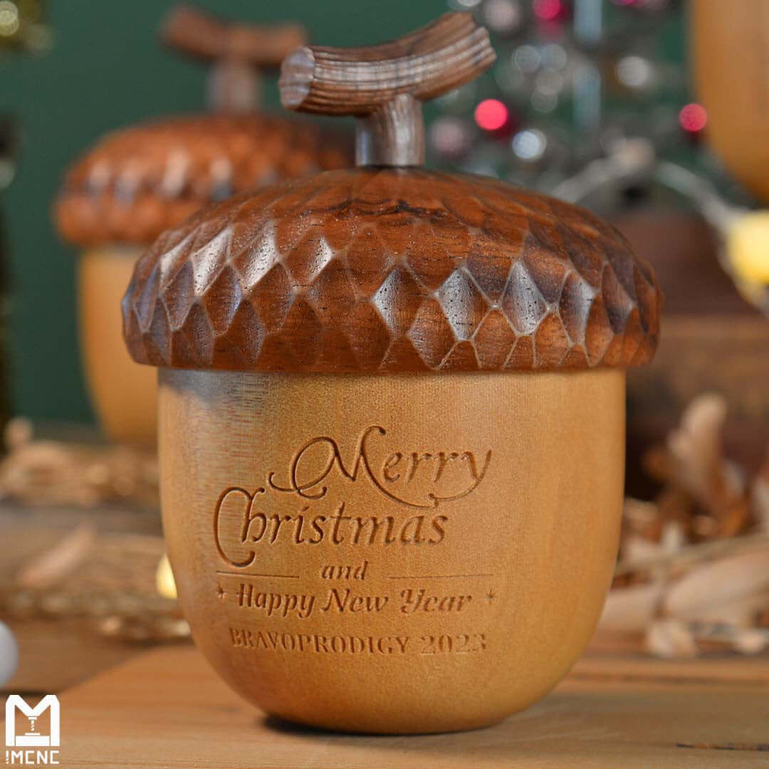 Close-up of CNC-engraved wooden acorn bells with ‘Merry Christmas and Happy New Year’ message — handcrafted holiday decoration made using IMCNC mini CNC Cylinder router.