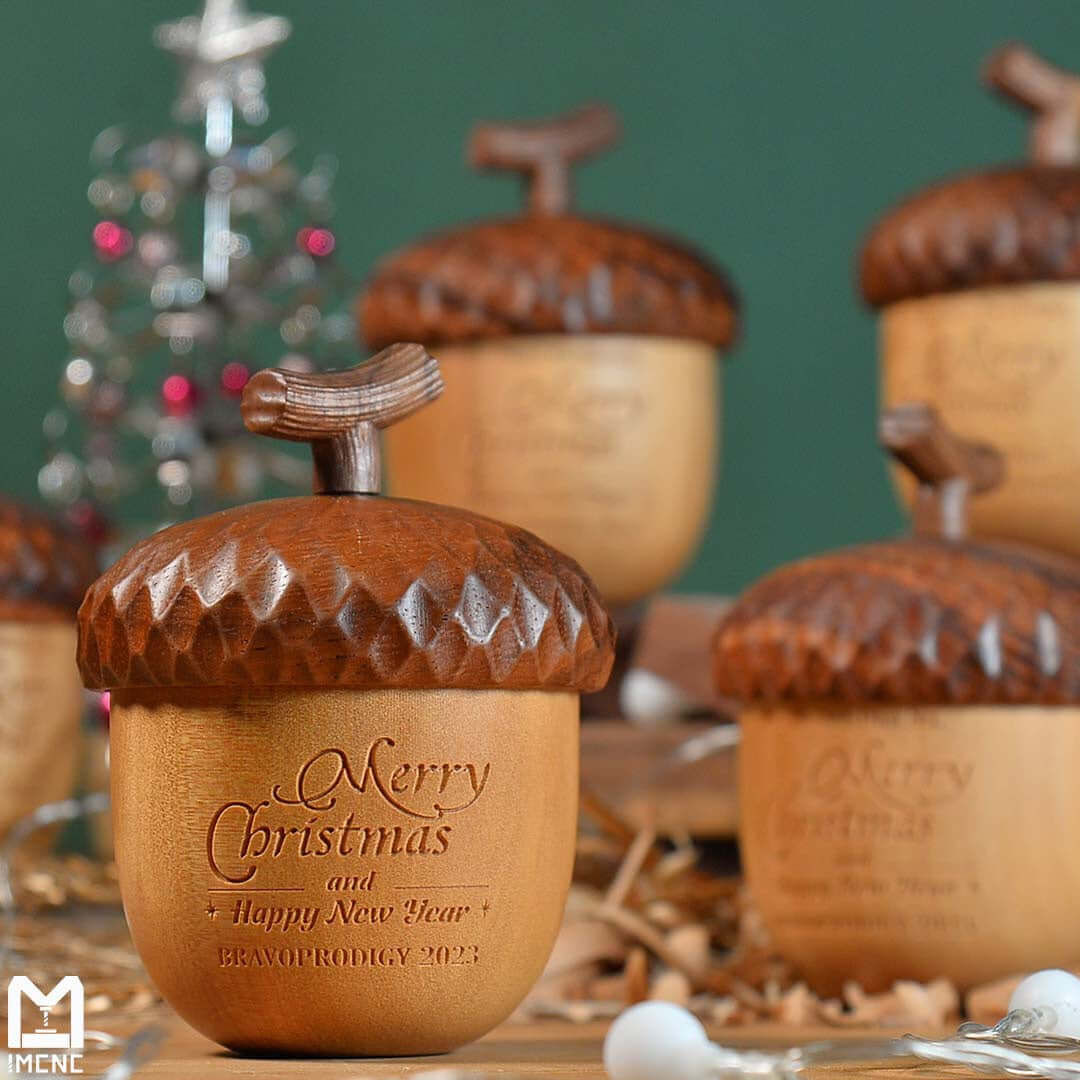 CNC crafted wooden acorn bells with CNC-engraved "Merry Christmas and Happy New Year" message — festive holiday gift created with IMCNC mini CNC router.